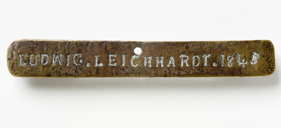 Brass nameplate of Ludwig Leichardt 1848, discovered attached to a partly burnt firearm in a bottle tree near Sturt Creek, Western Australia, by an Aboriginal stockman named Jackie. Photo: Dragi Markovic, National Museum of Australia.