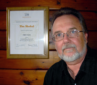 Andrew Perala and the award on the wall. Photo courtesy of Andrew Perala.