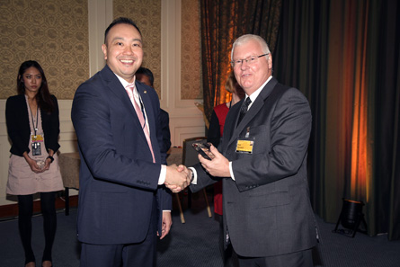 Winner of the Best New Circulating Coin Innovation, Process or Product accepted by Lenard Cheung, Royal Canadian Mint (left). Presentation made by Rick Haycock, IACA.