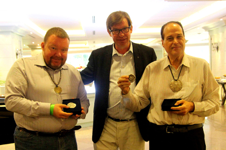Vasilijs Mihailovs (left); I.A.P.N. member and Thai coinage expert Jan Olav Aamlid (center); Ronachai Krisadaolarn (right) at the award ceremony in Bangkok. Mihailovs and Krisadaolarn are displaying their I.A.P.N. Book Prize Medals.