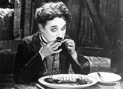 The Tramp resorts to eating his boot in a famous scene from 'The Gold Rush' (1925)/ Wikipedia.
