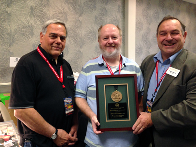 Club member, Donald Cleland receiving the President's Award at the show by Walter Ostromecki, American Numismatic Association president with Joe Cavallero, LVNS president. Photo: CKShows.com