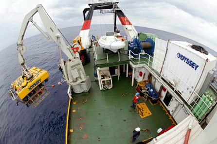 Odyssey's eight-ton Remotely Operated Vehicle (ROV) ZEUS is launched from Odyssey's 251' archaeological platform the Odyssey Explorer. The ROV descends to the ocean floor to conduct work on a deep-ocean shipwreck sites while operation is directed by the archaeologist and project manager aboard the Odyssey Explorer. Copyright: Odyssey Marine Exploration, Inc., www.OdysseyMarine.com.
