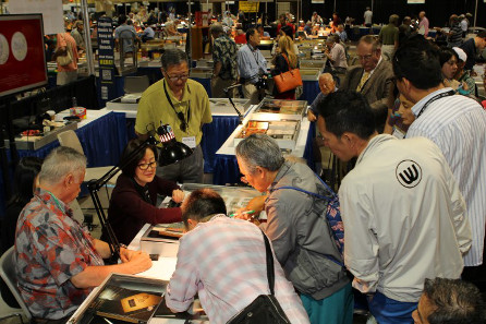Eager collectors and the public brought Chinese coins to Long Beach for free, expert appraisals. Assisting at this session were PCGS Co-Founder Mr. David Hall (seated left) and Ms. Zuo Jinghua, Managing Director of Beijing ChengXuan Auctions Co., Ltd. (seated on the right)./ Photo credit: Phil Arnold.