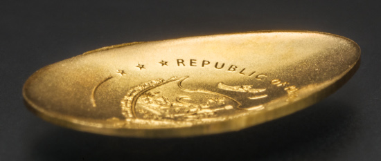 This curved and egg-shaped coin combines the look of a three-dimensional egg with the form of a two-dimensional coin.