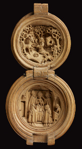 Rosary bead or prayer-nut; boxwood; carved. 1490-1530. Opening in two halves: St Hubert adoring the stag and enthronement of St Hubert. The Waddesdon Bequest. © The Trustees of the British Museum.