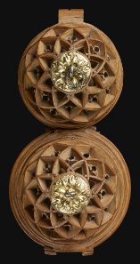 Rosary bead or prayer-nut; boxwood; carved. 1490-1530. Opening in two halves: St Hubert adoring the stag and enthronement of St Hubert. The Waddesdon Bequest. © The Trustees of the British Museum.