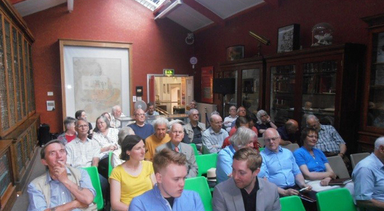 The audience awaits the days' proceedings.
