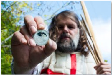 Modern day longbowman and Agincourt re-enactor, Graham Anderson, with The Royal Mint's coin marking 600 years since the Battle of Agincourt.