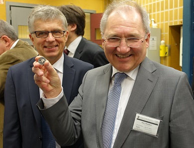 Peter Hofelich (r.) and Mint Director Dr Peter Huber are happy about the first polymer coin being struck. Photograph: UK.