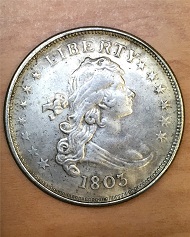 Historic, genuine 1803 Draped Bust design U.S. silver dollars in Very Fine condition are currently valued at about $3,000. This counterfeit 1803-dated dollar was recently offered in a Hong Kong flea market for less than $3. Photo by Donn Pearlman.