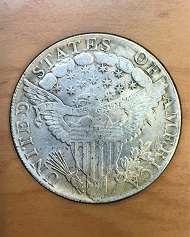 Historic, genuine 1803 Draped Bust design U.S. silver dollars in Very Fine condition are currently valued at about $3,000. This counterfeit 1803-dated dollar was recently offered in a Hong Kong flea market for less than $3. Photo by Donn Pearlman.