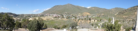View from one of the cemeteries to Virginia City, or rather what is left of it. Emerging from the hill, the silver ore runs underneath the city, right to the houses in the valley. Photograph: UK.