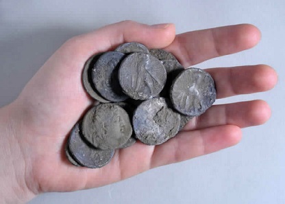 The coin hoard before cleaning. Photo: Clara Amit, Israel Antiquities Authority.