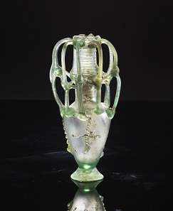 Multi-handled bottle. Eastern Mediterranean, 6th cent. AD. Greenish clear glass. H 22.6 cm. From the Shlomo Moussaieff Collection. With export permission from the Israel Antiquities Authority. Estimate: 18,000,- euros. From Gorny & Mosch sale 248 (June 30, 2017), No 426.