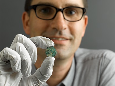 Assistant Curator Tom Cadbury showing a coin from the Constantinian era. ©RAMM.
