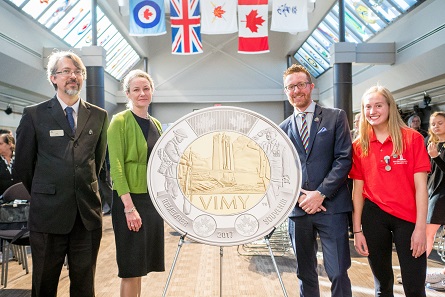 From left: Military Museums Senior Curator Rory Cory, Royal Canadian Mint President and CEO Sandra Hanington, Vimy Foundation Executive Director Jeremy Diamond and Bishop Carroll High School Student Rachel Barlow unveil a $2 circulation coin commemorating the 100th anniversary of the Battle of Vimy Ridge at the Military Museums in Calgary, AB (October 5, 2017).