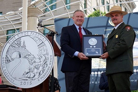 Associate Director David Croft presents coins to Superintendent Mark Woods.