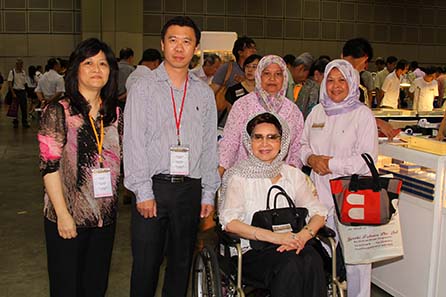 Kitty Quan, CEO of Panda America, Peter Yeung, President of Panda America, HRH the Crown Princess of Pahang, Malaysia, Princess Azizah Iskandar, and her attendants. The Crown Princess attended SICF 2011 to have her gold coins appraised (left to right)