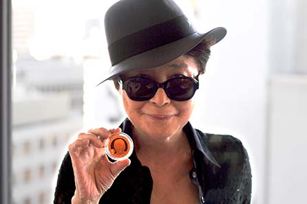 Yoko Ono presenting the one-off strike of a John Lennon coin in 22 carat gold.