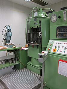 This is a coining press specially equipped to produce an especially high relief from the Sack and Kiesselbach Company.