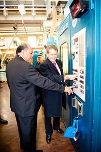 High Commissioner of Samoa and the Assistant Treasurer starting one of the presses up to make the 10 sene.