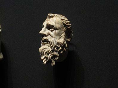 An old man's head. Part of a kline bed.