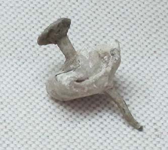 Curse tablet, pierced by a nail. Photograph: KW.