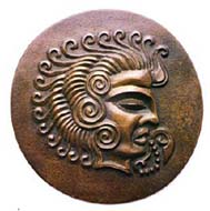 Coriosolite sun-god with wave-like curls of hair and sacred 'speech scroll' coming from mouth. Bronze medallion by Major N.V.L. Rybot. Source: A.L.T. McCammon, Currencies of the Anglo-Norman Isles, Spink 1984.