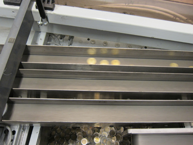 Taking the coins into the correct box is a rush job. Photo: UK.