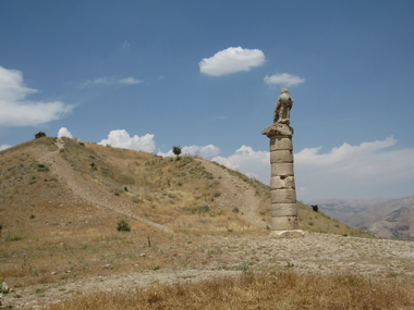 Column with eagle in front of tumulus. Photograph: KW.