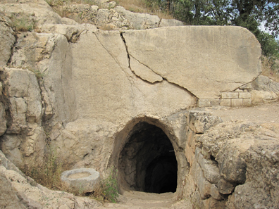 Entrance to a tunnel in a wall of rock full of inscriptions. Photograph: KW.