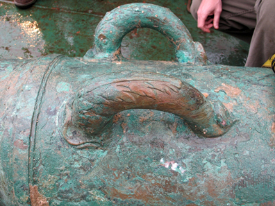 View of the dolphin handles adorning the 42-pounder bronze cannon recovered from the shipwreck site of HMS Victory. Source: Odyssey Marine Exploration, Inc.
