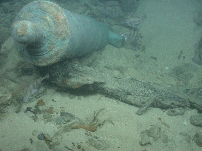 Bronze cannon protruding from a sandbank on the shipwreck site of HMS Victory. Source: Odyssey Marine Exploration, Inc.