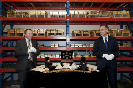 Ian E. Bennett, President of the Royal Canadian Mint Board and Marc Carney, Governor of the Bank of Canada unveil Canada's first gold coins at the Mint's Gold Refinery Vault in Ottawa, Ontario on November 28, 2012.