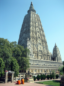 The Mahabodhi temple in Bodhgaya, India. Two monks are meditating in front of it. The tree under which the Buddha attained enlightenment is on the left, behind the monks. This temple is the number 1 pilgrimage site of Buddhism in the world. Photo: Wikipedia / http://creativecommons.org/licenses/by-sa/2.5/deed.en.