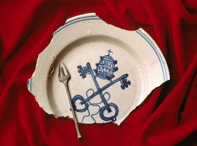 Among the glazed ceramic ware is a Sevilla Blue-on-White plate which has a
