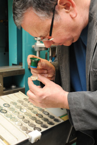 Brodschat examines the coins. Photographer Norbert Meise/Stephan Tiede Berlin © Staatliche Münze Berlin.