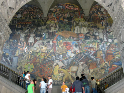 One of the monumental socio-critical wall paintings at Palacio Nacional, painted by Diego Rivera. When we visited the site it had already become much too dark to take a picture of it. Photograph: Wikipedia / Thelmadatter.