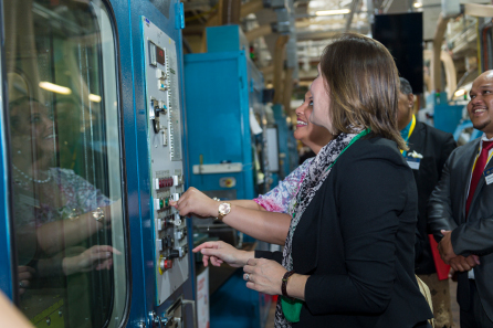 Her Royal Highness and the Parliamentary Secretary striking one of Tonga's brand new coins. © Royal Australian Mint.