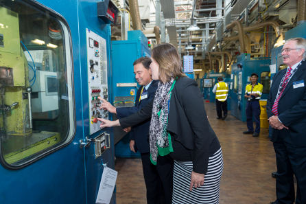 The Minister of Finance and the Parliamentary Secretary striking one of Cook Islands' coins. © Royal Australian Mint.