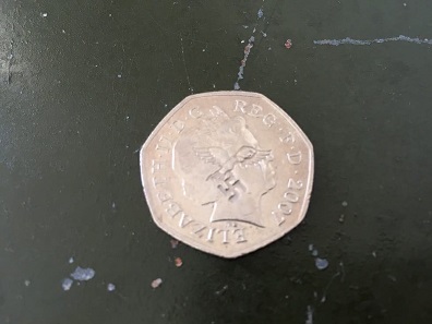 Defaced by unknown persons, coins like this 2007 50p coin currently circulate in England.