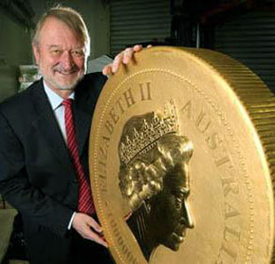 Ed Harbuz, CEO of The Perth Mint, stands beside the massive 1 Tonne Australian Gold Kangaroo Coin.
