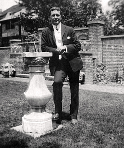 John McCrae leaning against a sundial, c.1912. Guelph Museums, Reference No. M983.5.1. Source: Wikipedia.